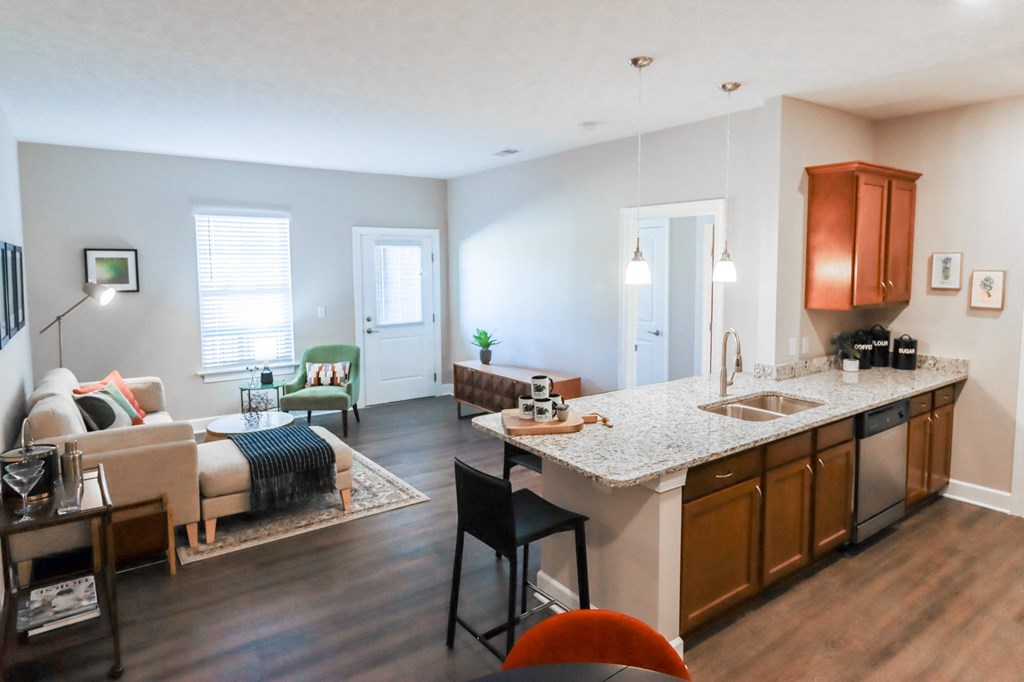 a living room and kitchen with a couch and a table