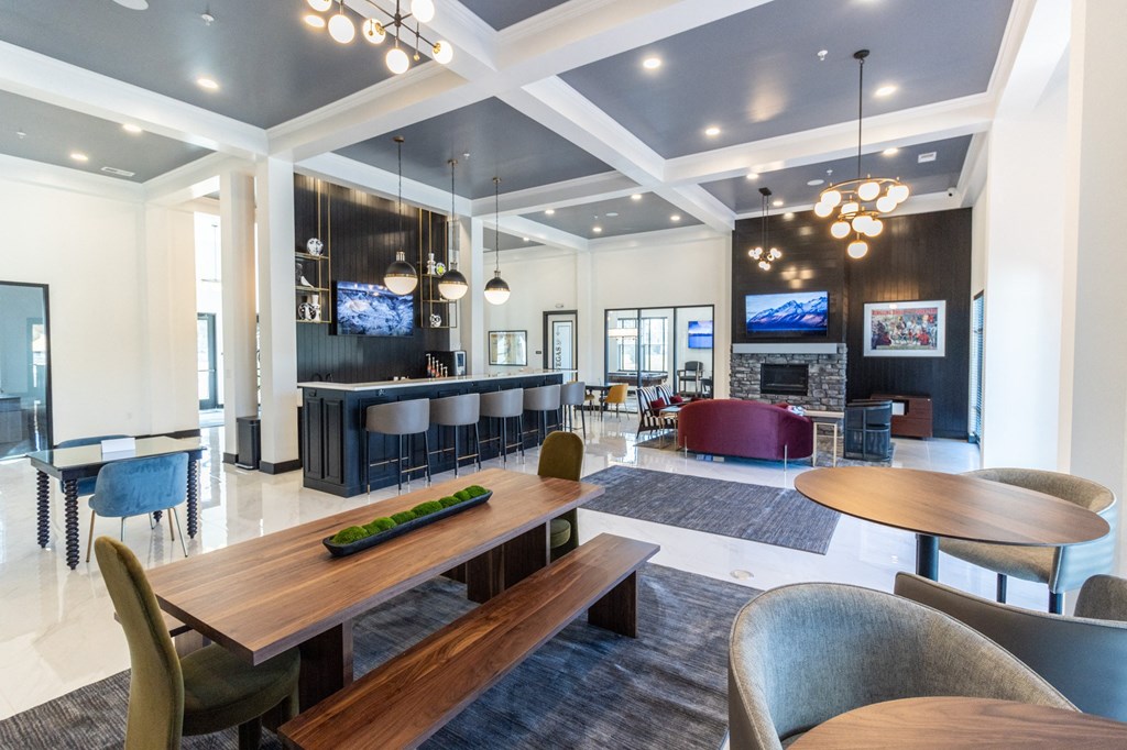 a communal area with tables and chairs and a fireplace