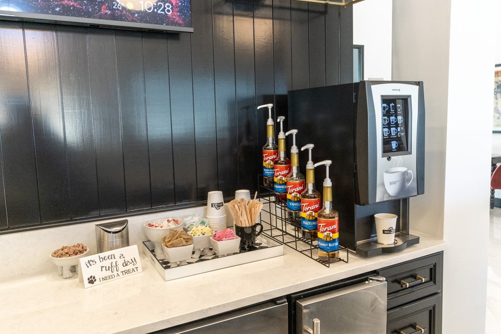 a kitchen counter with a tray of food and a coffee machine