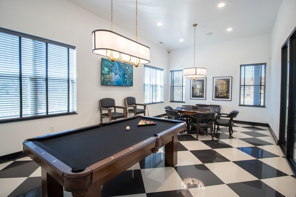 a games room with a pool table and a table and chairs