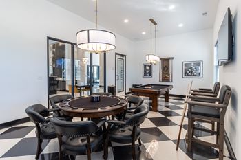 a dining room with a table and chairs and a pool table