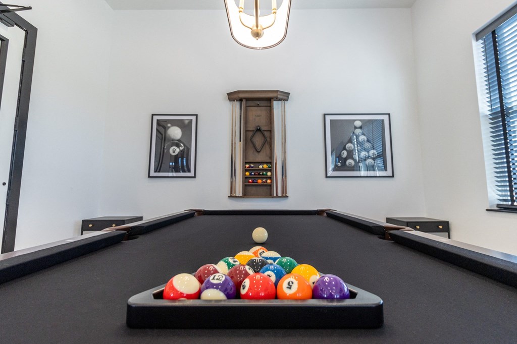 a billiards table with a bunch of balls on it