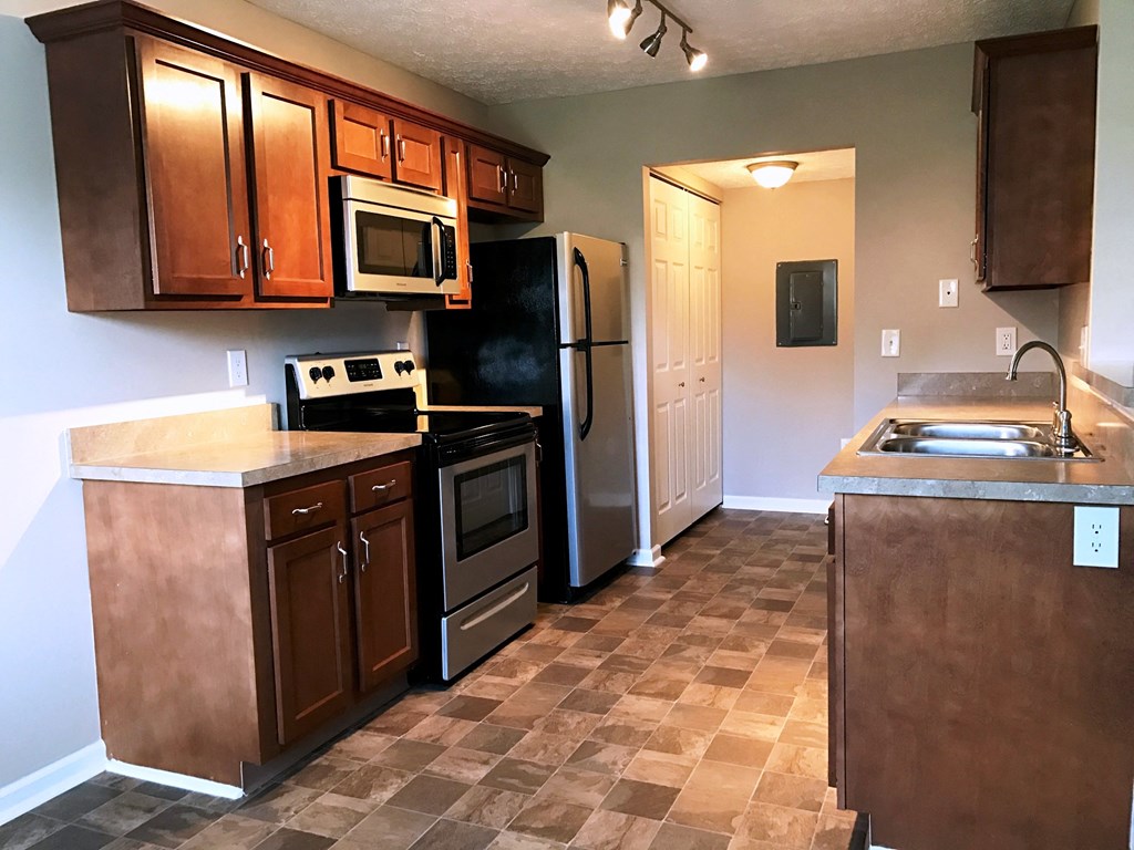 a kitchen with stainless steel appliances and wooden cabinets
