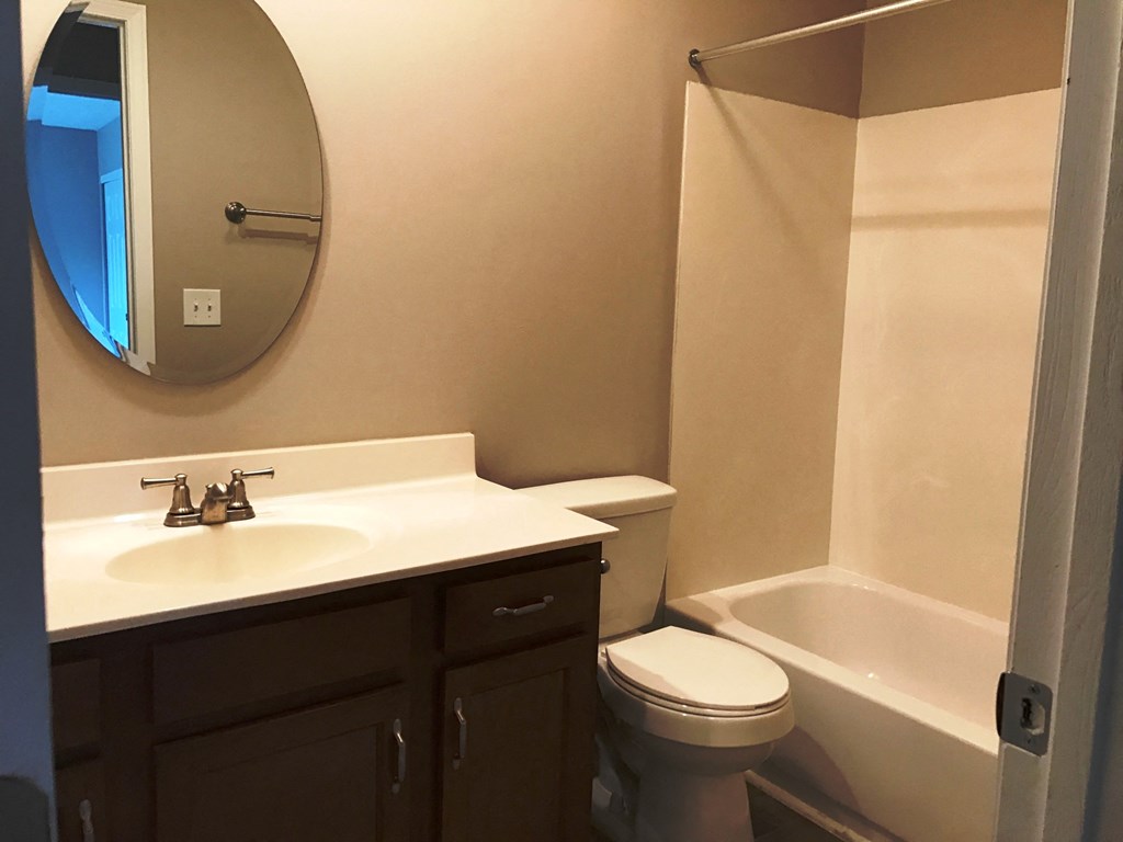 a bathroom with a sink toilet and a bath tub