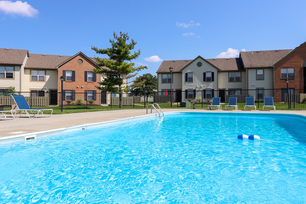 a swimming pool with apartments in the background