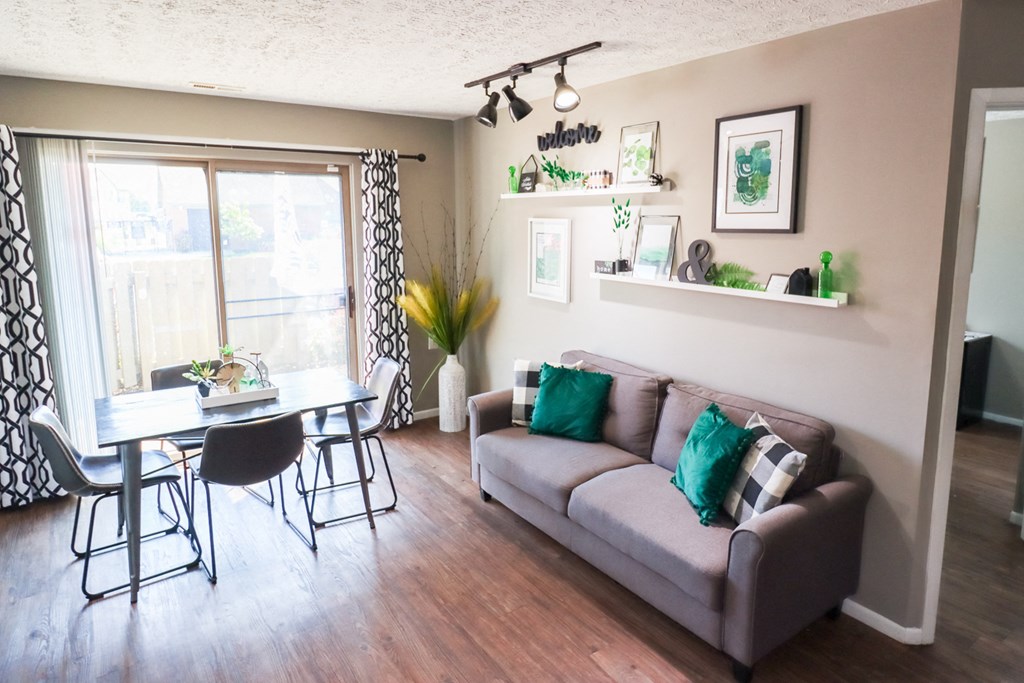 a living room with a couch and a dining room table
