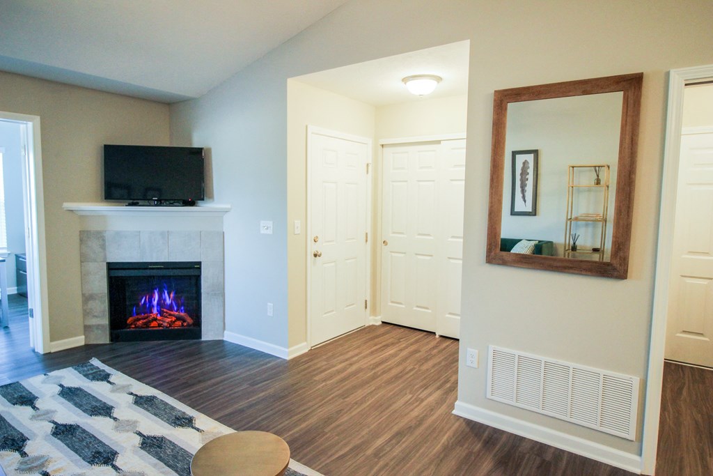 a living room with a fireplace and a television