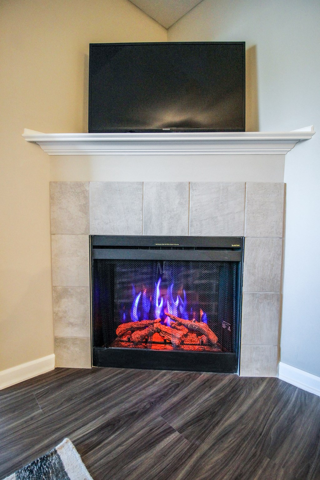 a fireplace with a tv above it