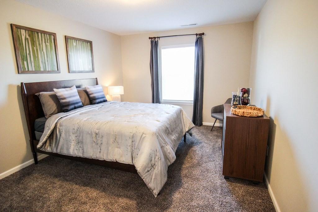 a bedroom with a bed and a desk