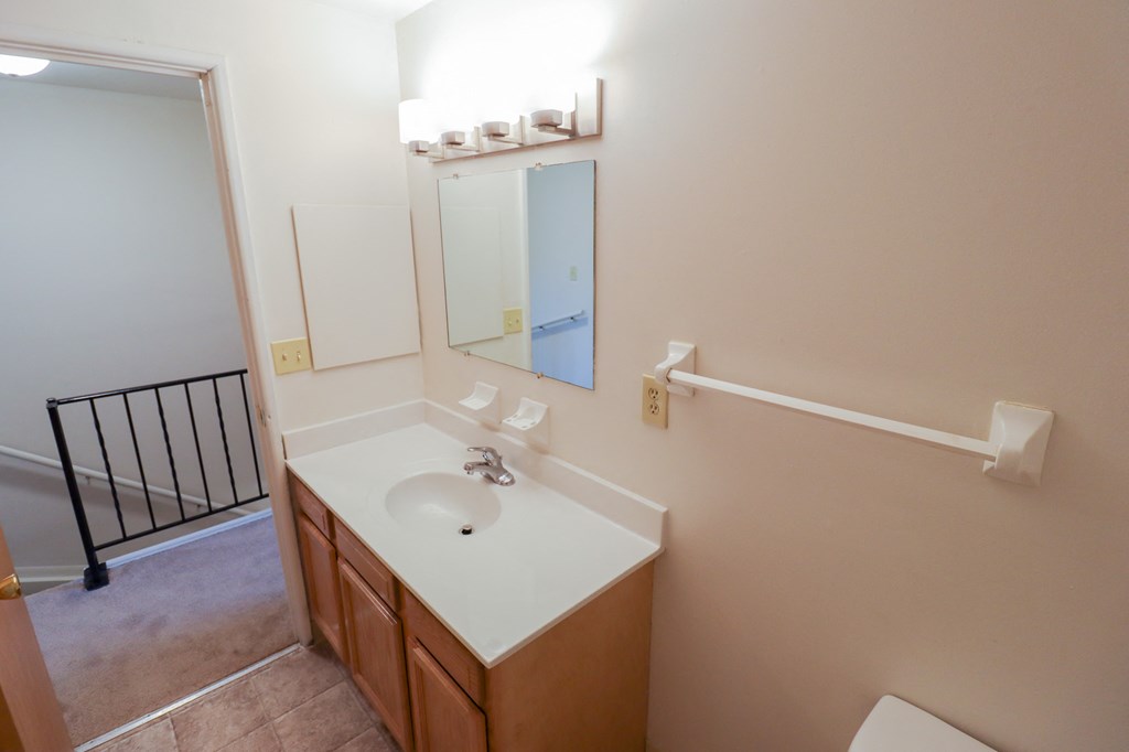 an empty bathroom with a sink and a mirror