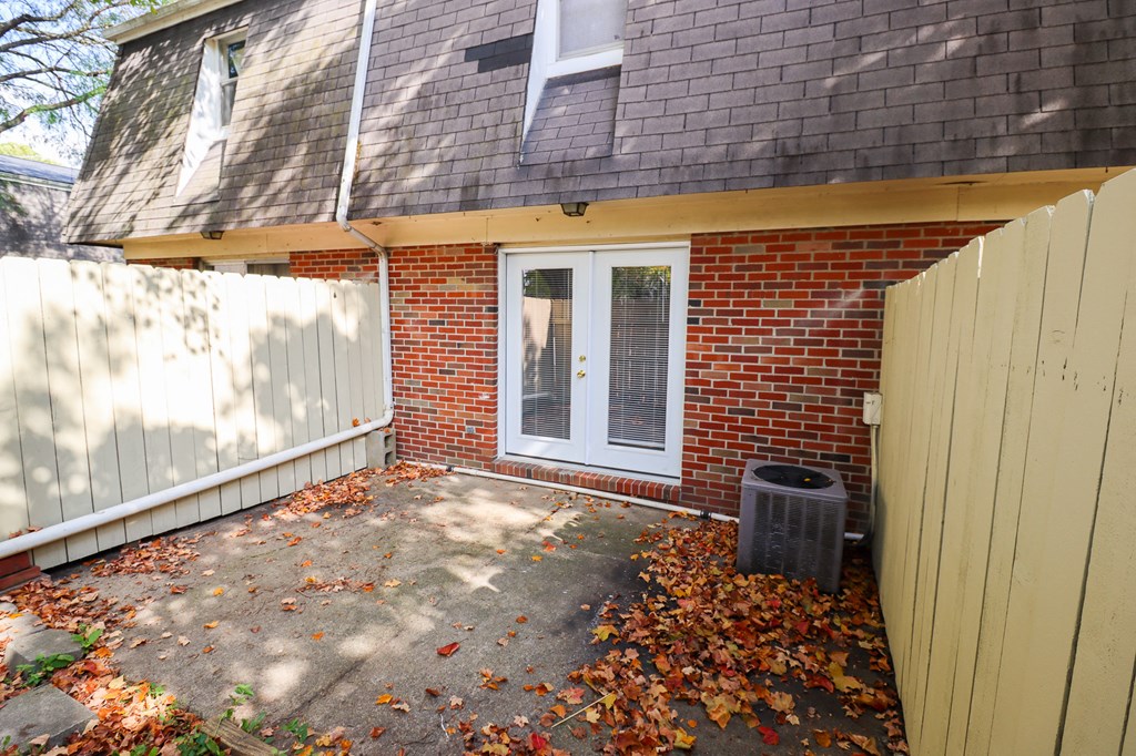 a small porch in front of a brick house