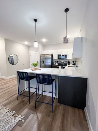 a kitchen with an island and two bar stools