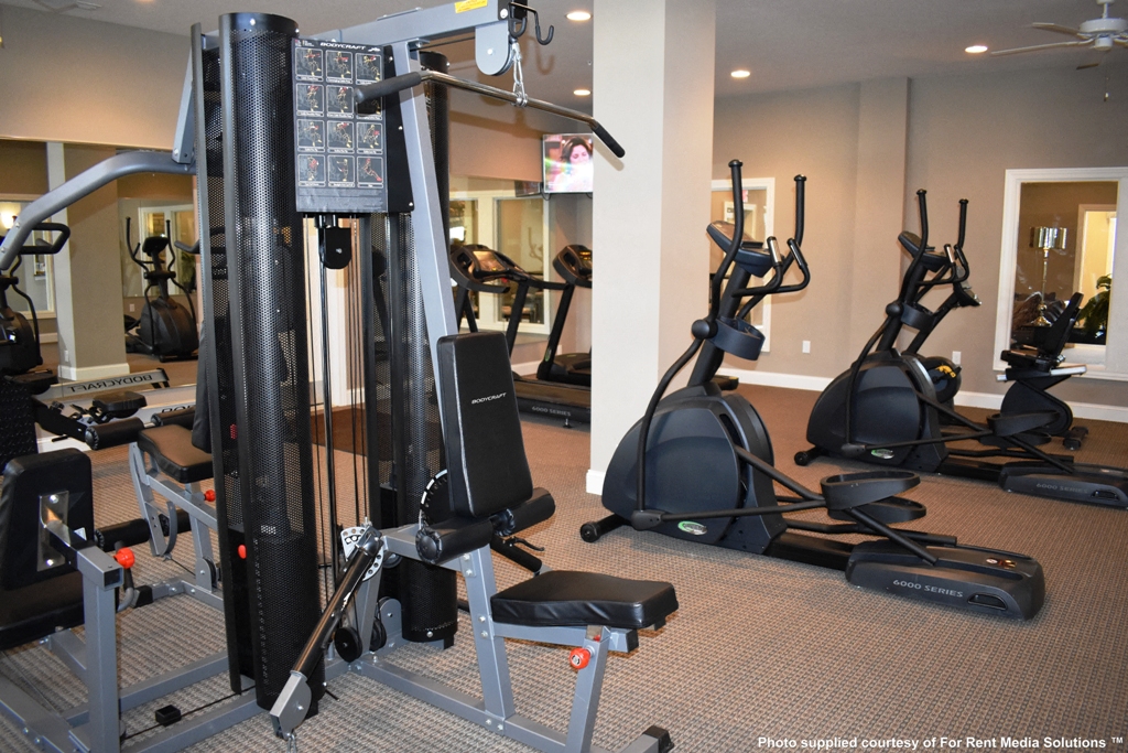 a gym with various exercise equipment in a hotel gym