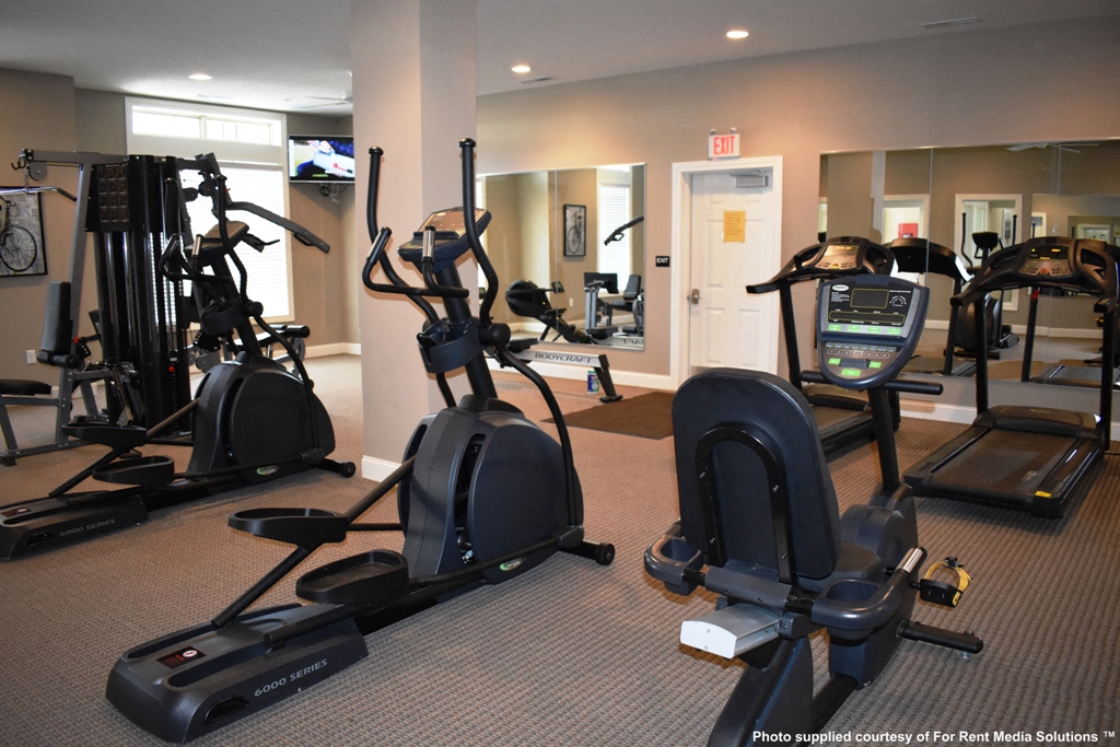 a gym with cardio machines and other exercise equipment