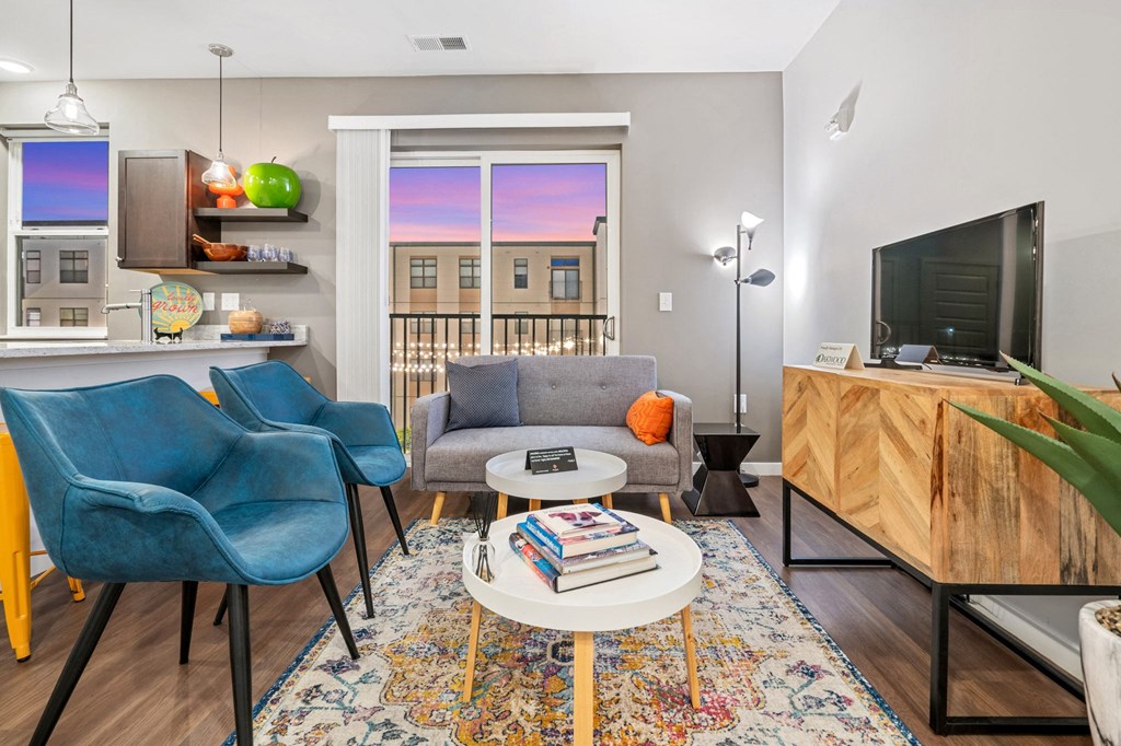 a living room with a couch and chairs and a television