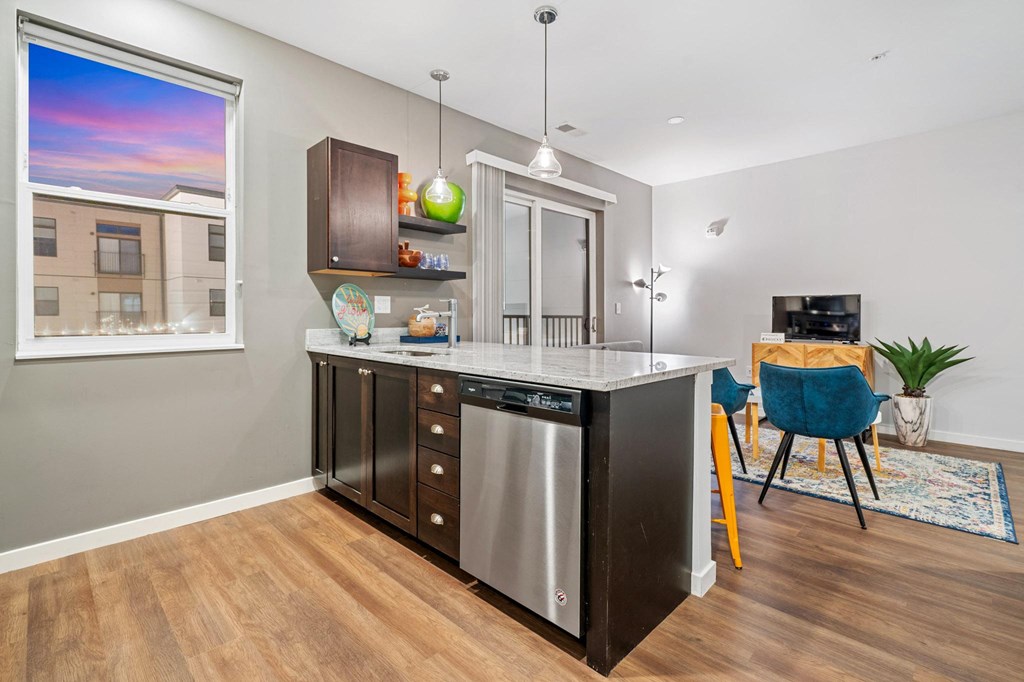 a kitchen with an island and a dining room with a window