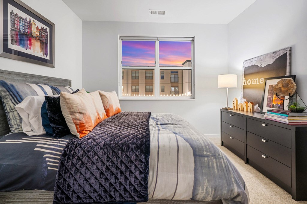 a bedroom with a bed and a window