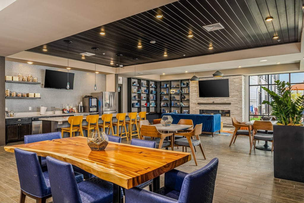 a dining room with tables and chairs and a bar and television