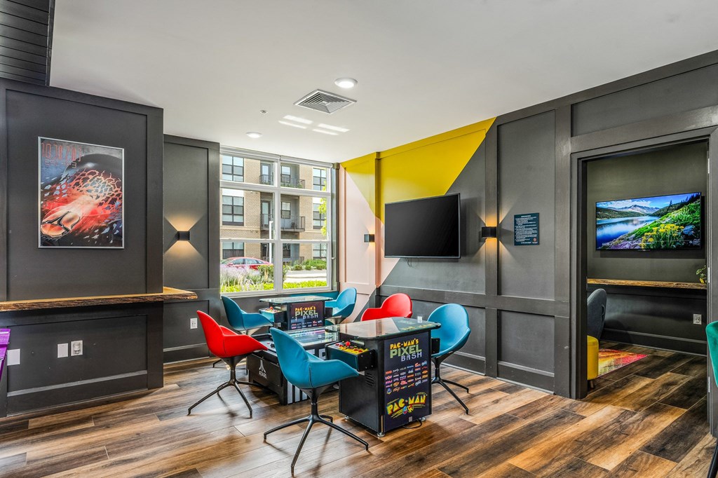 a game room with a table and chairs and a tv