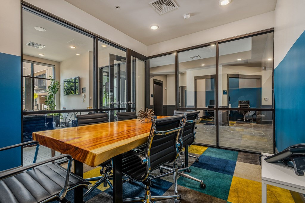 a conference room with a wooden table and chairs