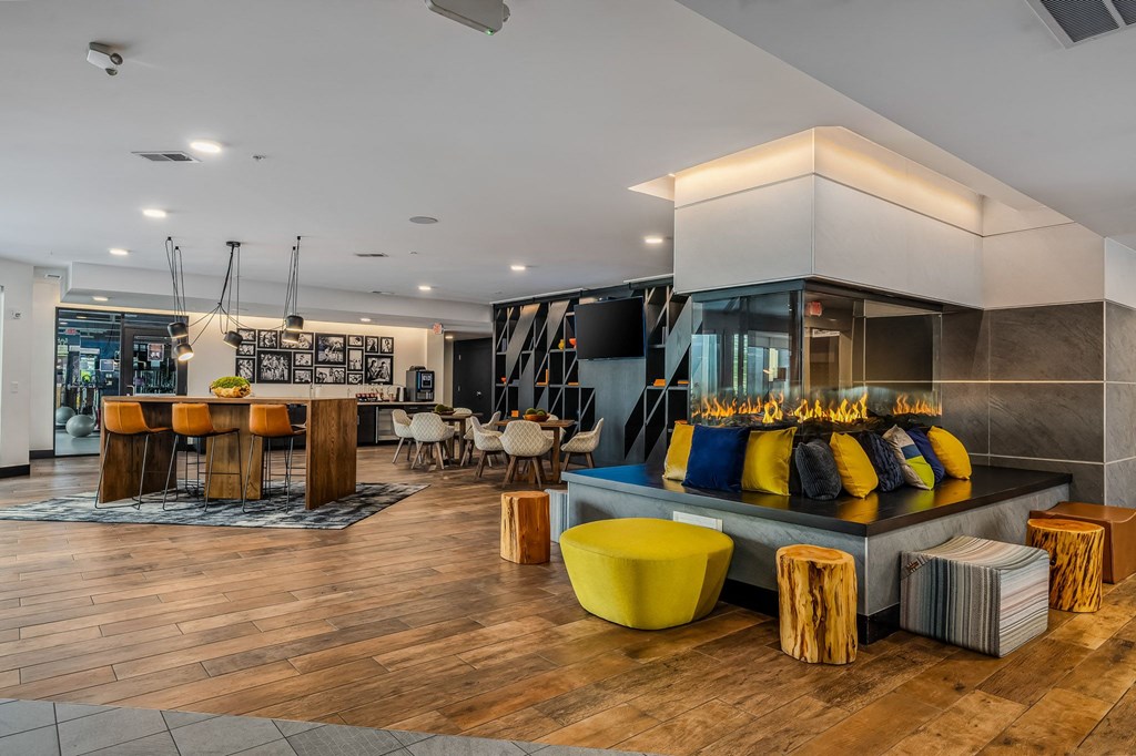 the lobby of a hotel with a bar and tables