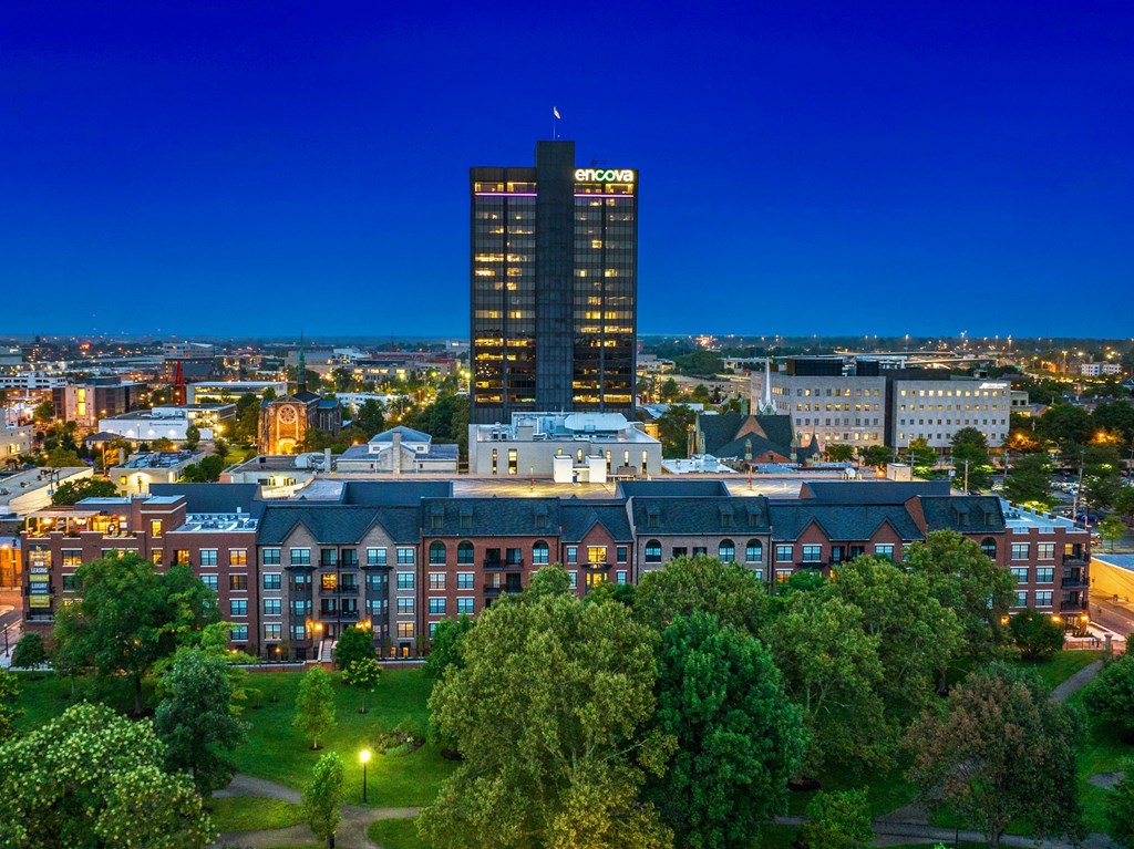a cityscape at night with a tall building in the background