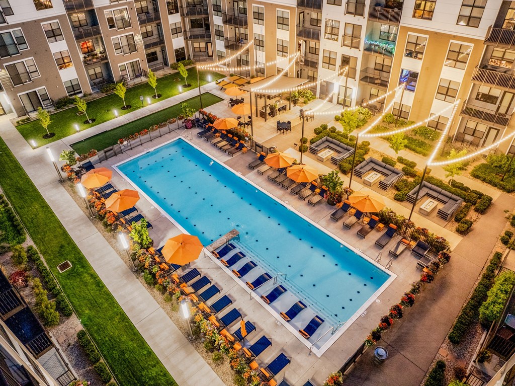 an overhead view of a swimming pool in front of an apartment building