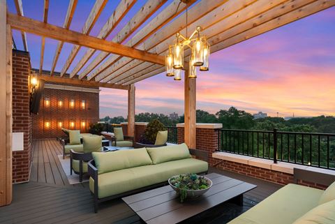 a deck with a wooden pergola and a view of a sunset