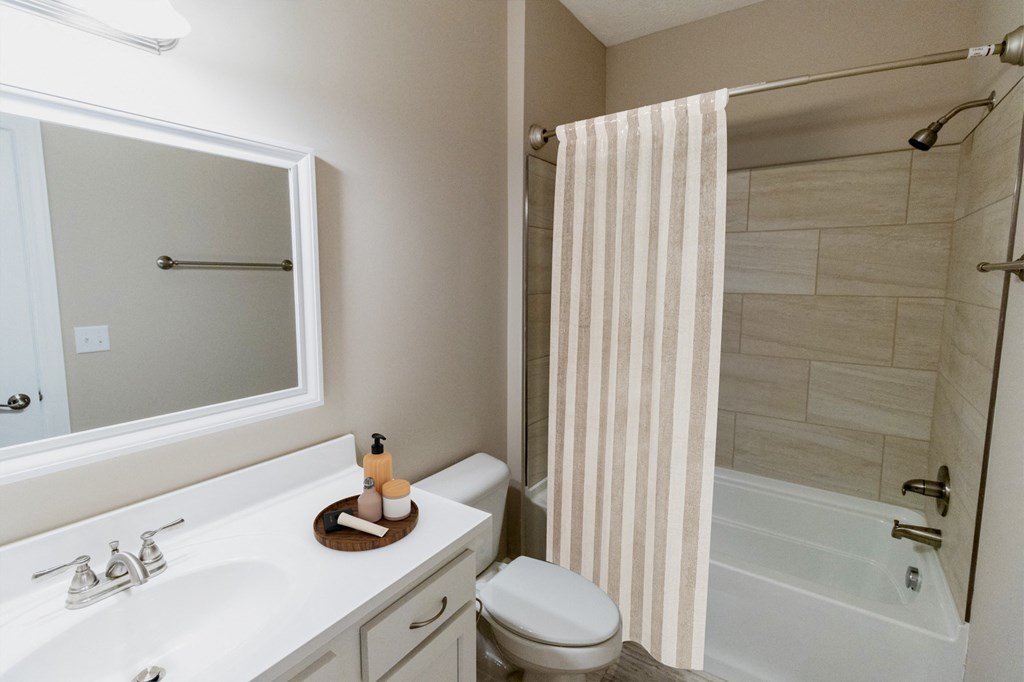 a bathroom with a shower and a sink and a toilet