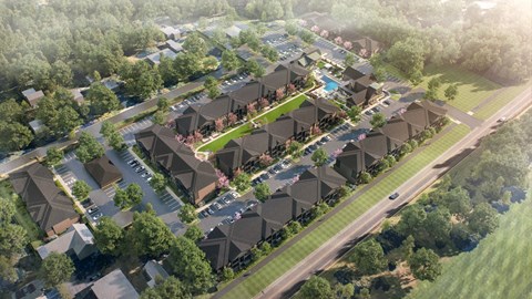 A bird's eye view of a residential area with houses and greenery.
