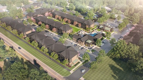 A bird's eye view of a residential area with houses and a parking lot.