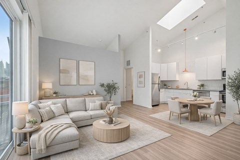 A modern living room with a large grey sofa and a wooden coffee table.