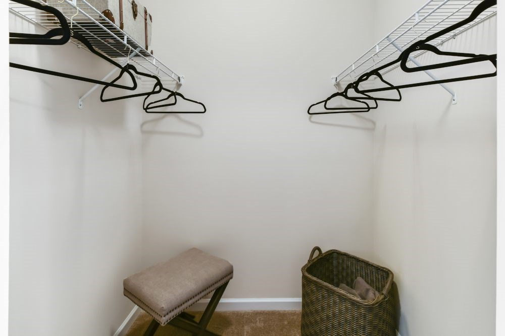 A room with a chair and a basket on the floor.