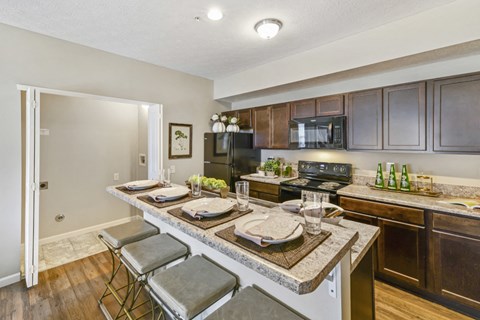a kitchen with a long counter and a dining table