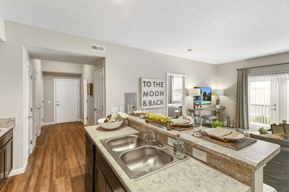 A kitchen with a sign that says "To the Moon & Back".