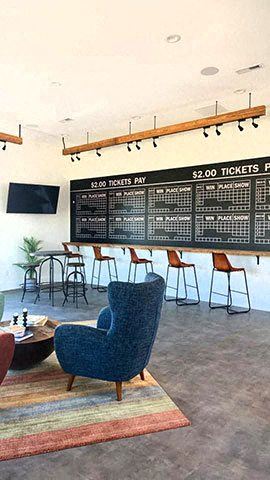a lobby with a large chalk board and chairs