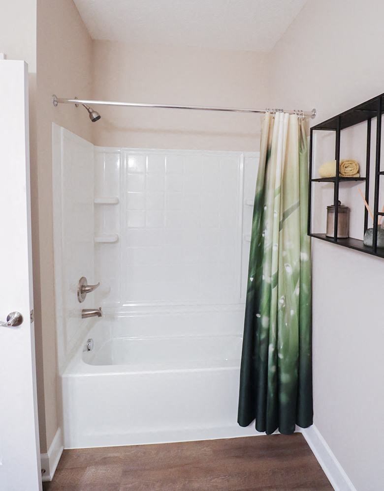 a bathroom with a white tub and a shower curtain