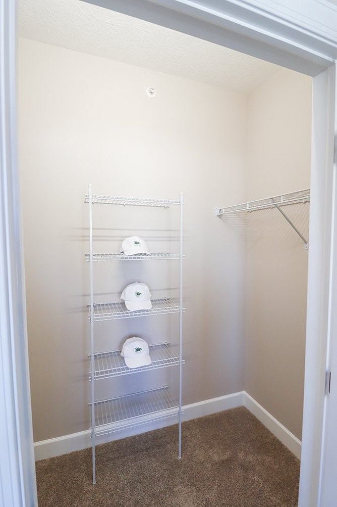 a bathroom with a closet filled with toilet paper