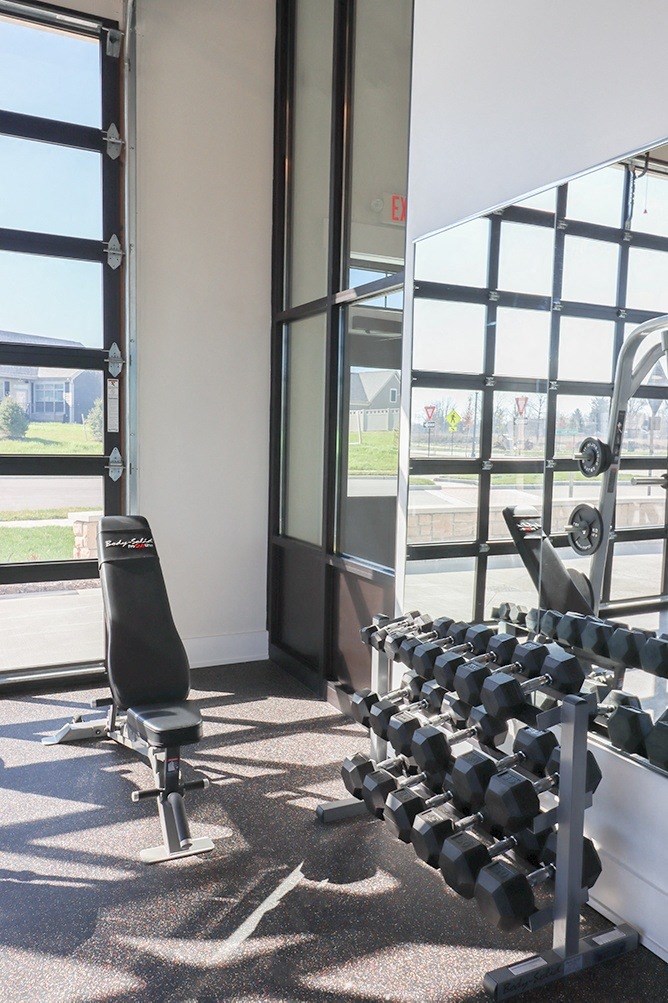 a gym with a row of weights on the floor
