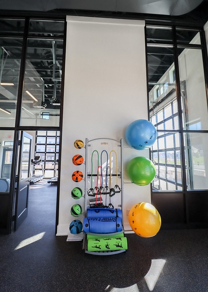 a white wall with a bunch of balloons and a trolley