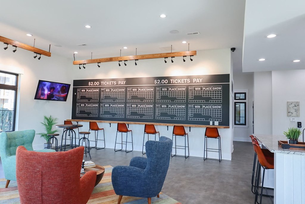 a lobby with chairs and a large board on the wall