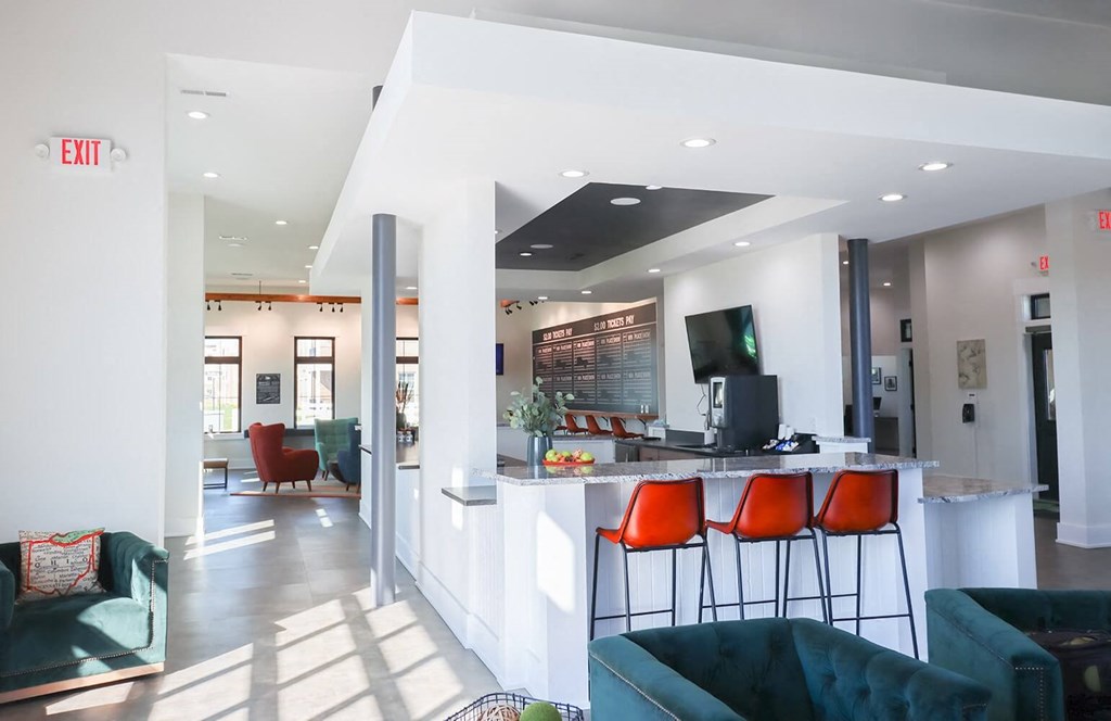 a living room with a bar and a kitchen