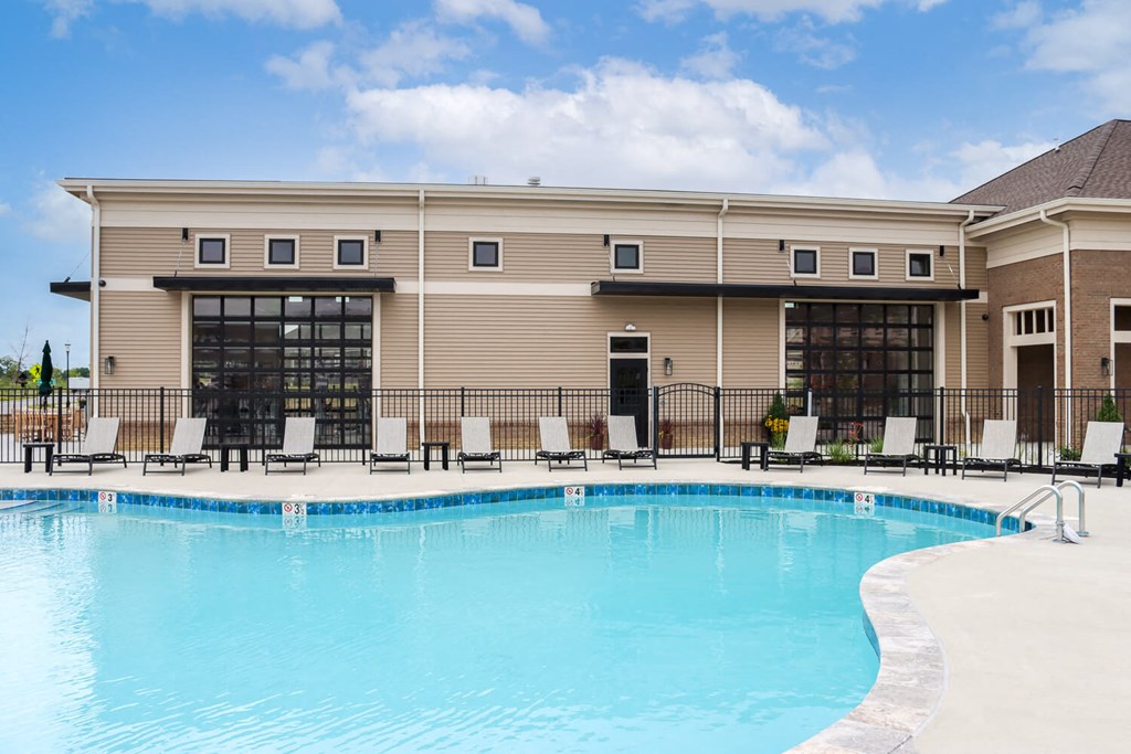 a swimming pool in front of a resort building