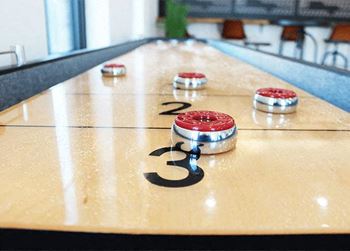 a bowling alley with red and white balls on it