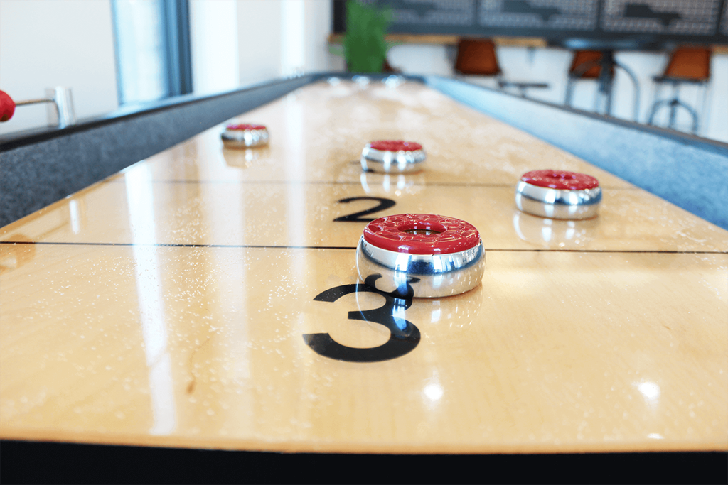 a shuffleboard court with red and white balls on it