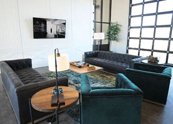 a living room with couches and chairs and a table