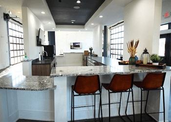 a kitchen with three bar stools