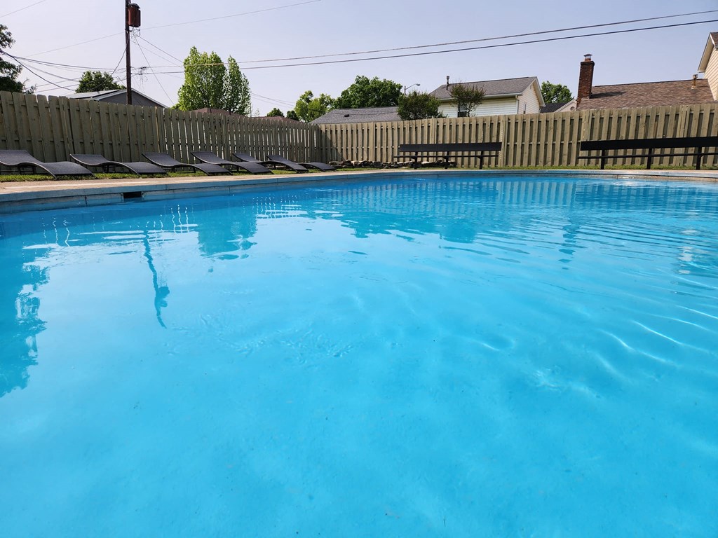 a large swimming pool with a fence around it
