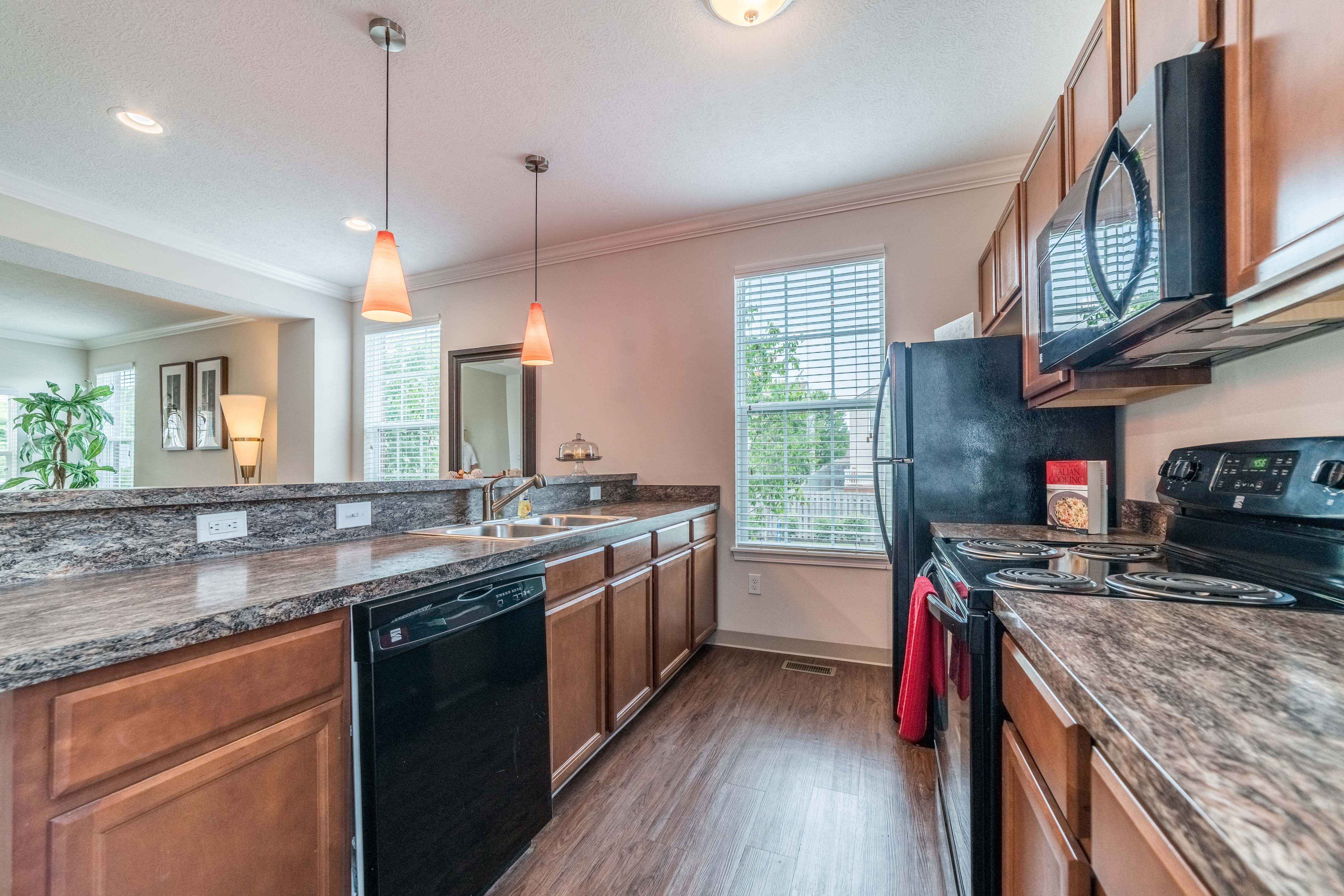 a kitchen with a counter top and a stove and a sink