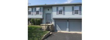 A house with a blue garage door.